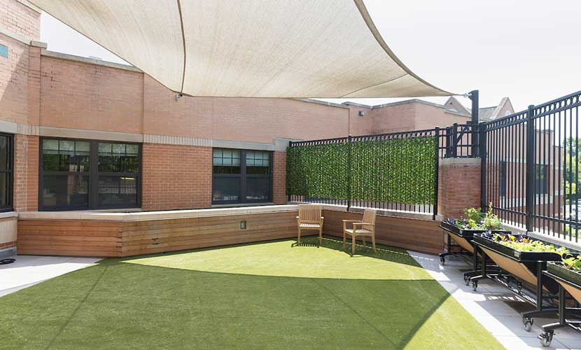 Peaceful covered outdoor patio with garden beds